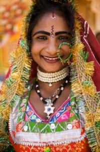 29 Feb 2004, Udaipur, India --- Smiling Indian Woman in Colorful Dress --- Image by © Dennis Degnan/Corbis